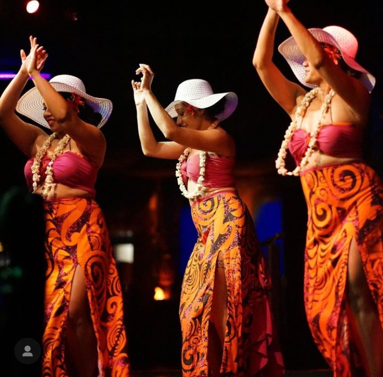 a group of women dancing at a luau